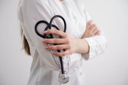 Doctor woman hands hold phonendoscope with heart lined cord Love for life help people problems in cardiology listen to heart medicine Medical confidentiality healthcare workers and pandemic conceptの写真素材