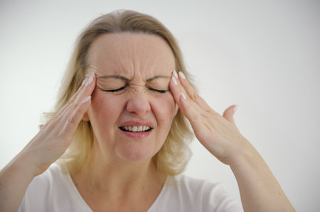 Photo of senior woman hands touch head ache pain suffer ill migraine sick isolated over grey color backgroundの写真素材