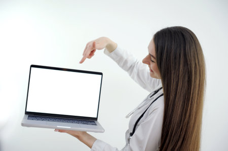Female doctor making video call on laptop mock up screen with patientの写真素材