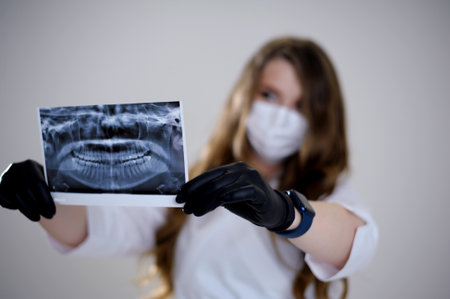 X-ray image of the jaw of all human teeth close-up. Magnetic resonance imaging of teeth. The doctor examines the x-ray of the tooth. Health care and medicine, dentistry, dentistry concept.の写真素材