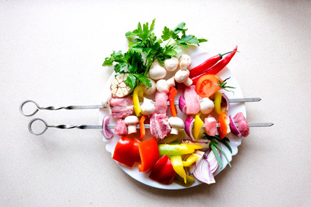 Shish Kebab on Skewers is Cooked on Barbecue at Street Food Festival. Pieces of pork roasted on BBQ. Cook prepares meat on the coals. Street kitchen. Fresh grilled food catering, party. Street market.の写真素材