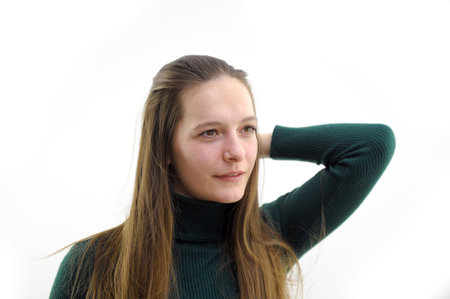 Beautiful smiling woman drying her long hair with dryerの写真素材