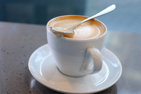 large cup of cappuccino with milk foam in the morning overhead shot cup of coffee latte in shape of a heart and coffee beans on an old wooden background Eating Foam Or Thick Froth Of Hot Coffee Latteの写真素材