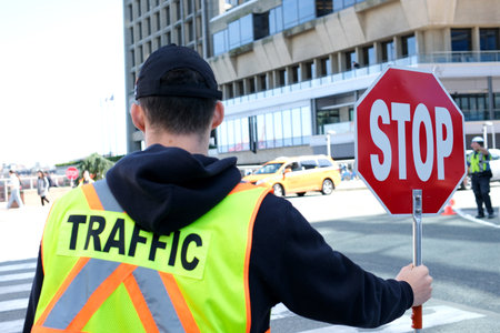 A construction road worker stopping traffic, holding a stop sign.の写真素材