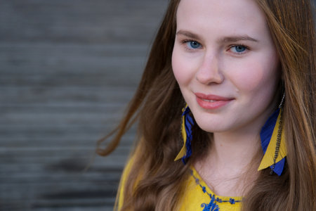 earrings in the form of the Ukrainian flag yellow and blue color young girl in a yellow embroidered...