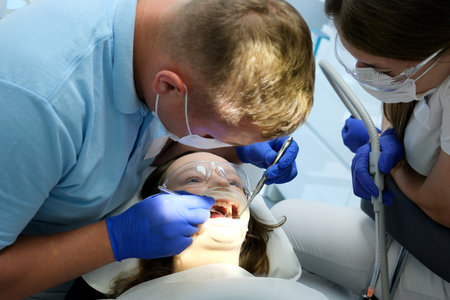Woman having teeth examined at dentists