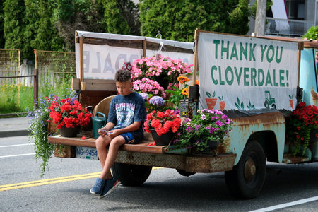 old rusty truck with the inscription Thank you cloverdale painted with carrots and flowers hats...