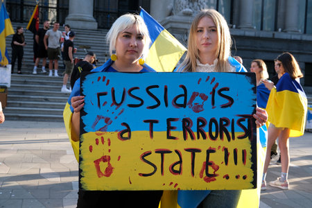 demonstration in Canada in city center against war in Ukraine people with flags of Ukraine in traditional national clothes Ukrainians men and women with posters Russia is a terrorist countryのeditorial素材