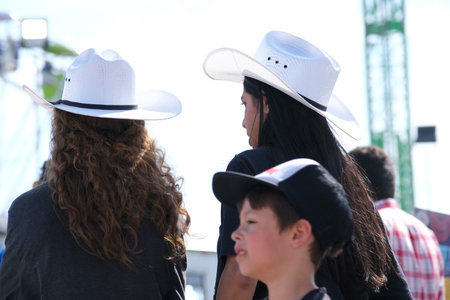 recreation fun fair people choose clothes dancing drink wine communicate with each other in fresh air near carousel swing families men and women tourists pass by audience real-time shooting Vancouverのeditorial素材