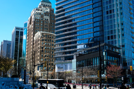 beautiful glass buildings skyscrapers rising into the blue sky without clouds Vancouver cherry blossoms in spring the camera slowly captures the cityscape office buildings the latest technologyのeditorial素材