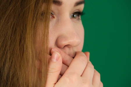 Girl shouting over isolated green backgroundの写真素材
