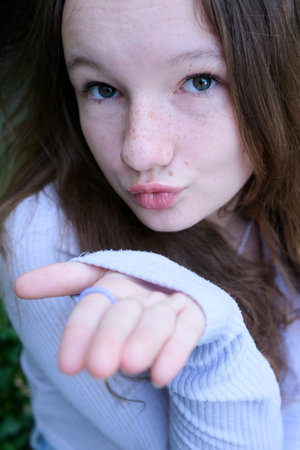 Air kiss girl Charming lovely woman sending an air kiss. Confess love lo a guyの写真素材