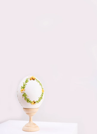 Happy Easter Table decorated with colorful Easter eggs in straw. Easter decoration. Easter tradition