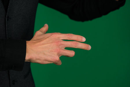 Female hand gestures on green screen: pointing or pressing.の写真素材