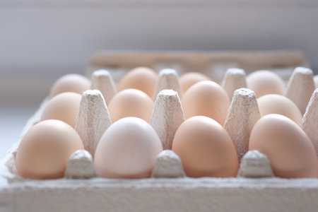 Fresh brown eggs in carton box rotating. Chicken eggs in packaging. Vertical footage for stories. Organic food. Close-up of hen eggs. Farm concept. Close-up in 4K, UHDの写真素材