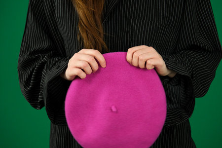 Closeup french beret hat isolated on green background.