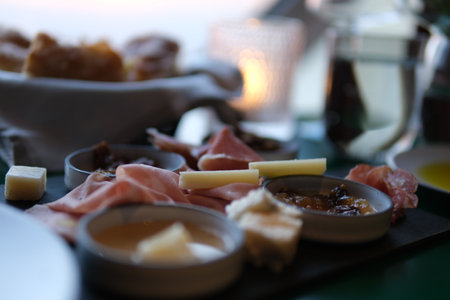 Cheese, meat, grapes and olives antipasto. Appetizer selection on plate. Top view with copy space. Flat layの写真素材