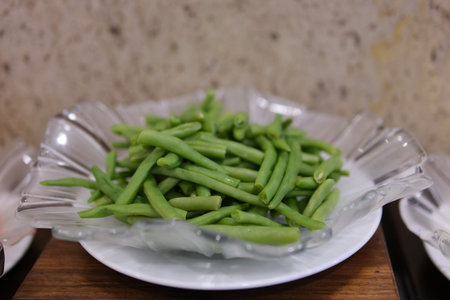 vibrant green beans starting to boil in a steaming pot. Cooking vegetarian and healthy eating concept.の写真素材