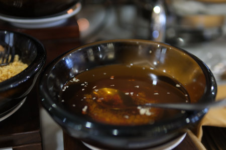 fish sauce with garlic chili pepper fish sauce Sweet and Sour Chili garlic dipping fish Sauce bowl isolated on white background, top view. pickle carrot and radish Vietnamese fish sauceの写真素材