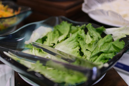 Preparing a fresh salad at the local salad bar in the afternoonの写真素材