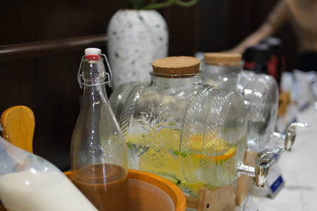 Glass beverage dispensers dispensers with fruits: grapefruit, orange, lemon. Welcome zone of drinks...