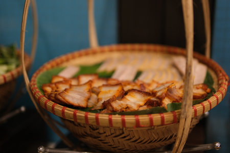 Basket sliced meat Rustic wholesome lunch of tasty savory meatballs in a spicy tomato and herb sauce served with a glass of beer and sliced baguette, close up overhead viewの写真素材