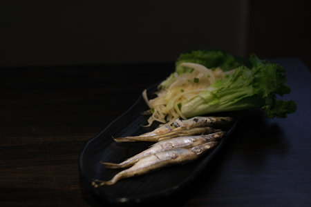 small grilled fish Oven baked fish sardines, with tomatoes, lemon and rosemary. Top view.の写真素材