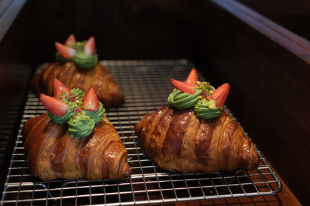 croissant with cream, strawberries, and blueberriesの写真素材