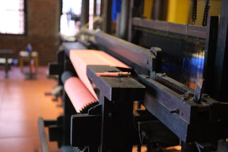 Separate silk worm via spinning wheel, Thai wisdom. process highlights sustainable textile making, natural materials, and the dedication in rural workshops.の写真素材
