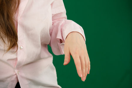 Set of videos showing female hands of young European woman in pink shirt making various gestures on green chroma key background with copy space for advertising and designの写真素材
