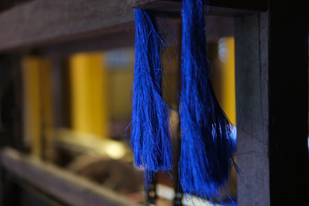 Separate silk worm via spinning wheel, Thai wisdom. process highlights sustainable textile making,...