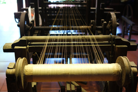 Separate silk worm via spinning wheel, Thai wisdom. process highlights sustainable textile making, natural materials, and the dedication in rural workshops.の写真素材