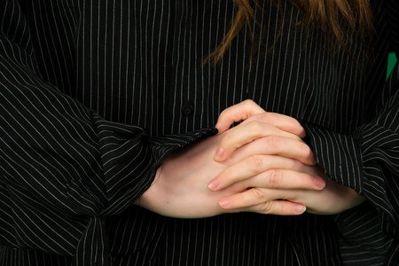 Set of videos featuring female hands of young European woman making different gestures on green chroma key background showing folded hands open palms and clenched fingers with copy spaceの写真素材