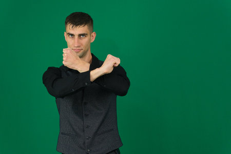 Set of videos with handsome European businessman in classic suit vest and black shirt showing different emotions gestures and confident poses on green chroma key background with copy spaceの写真素材
