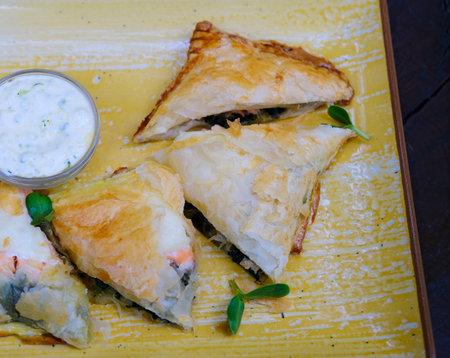 salmon pie and cheese quiche with herbs freshly baked for breakfast, sliced on a cutting board