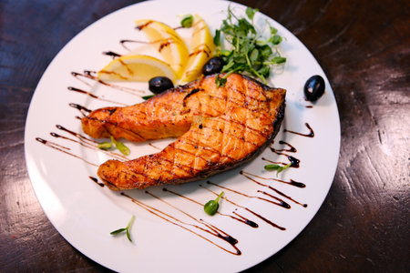 Grilled salmon olives with lemon, olives and fresh thyme. Selective focus