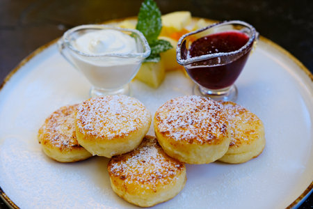 cottage cheese pancakes cheesecakes Homemade cottage cheese pancakes with sauce and strawberries....