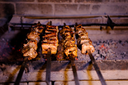 Yakitori outdoors (Japanese style chicken grill. Beef steaks on the grill with flames