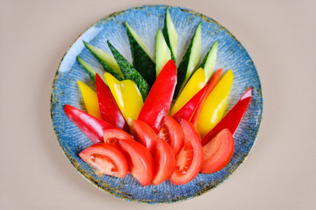 A colander filled with assorted fresh ripe tomatoes, red, heirloom, beef heart, pear shaped and cherry varieties with fresh basil. Rustic, farm to table aesthetic, harvest and cooking conceptの写真素材