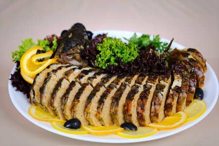 Herb-stuffed trout with tomatoes and green saladの写真素材