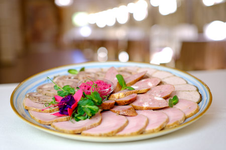 Grilled meat assortment platter in bright sunlight, overhead composition with rustic table setting.の写真素材