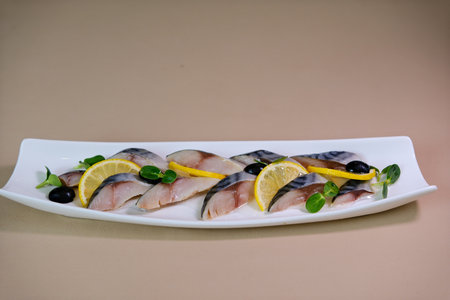 Fresh Mackerel Sashimi Served on Ice with Lemon and Garnishesの写真素材