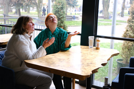 Women cafe conversation two women cafe terrace. Friendship meeting. Togetherness and female friendship. Trust her. Girls friends drink coffee and enjoy talk. True friendship friendly close relations.の写真素材