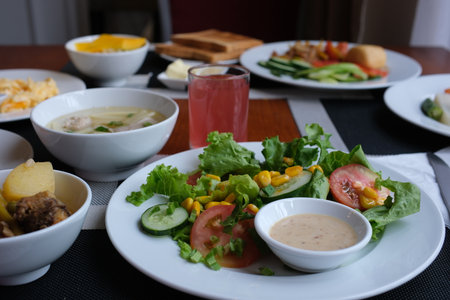 A beautifully presented meal features tender broccoli, savory dumplings, and fresh salad, perfectly...