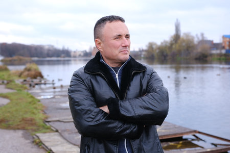autumn man leather jacket man in a leather jacket in an autumn park.