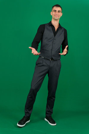 Various emotions and movements of a man in a gray suit on a green background in a vest and pants,...