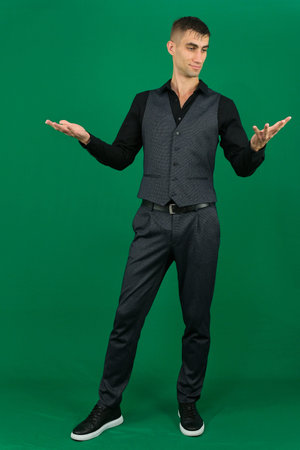 Various emotions and movements of a man in a gray suit on a green background in a vest and pants,...