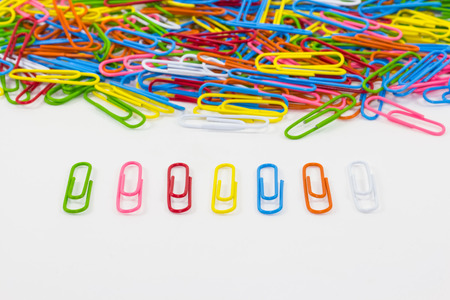 Colorful paperclips on white background focus on front seven clipsの写真素材