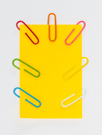 Colorful paperclips and post it on white background isolatedの写真素材