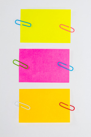 Colorful paperclips and post it on white background isolatedの写真素材